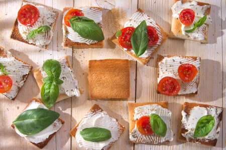 Tricolor cocktail canapes, cheese and tomato salad の写真素材