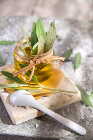 Presentation of a small glass jar containing olive oilの写真素材
