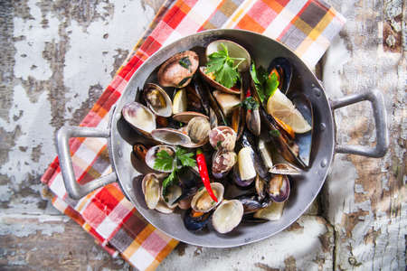 Preparing a soup made from seafood with garlic and parsleyの写真素材