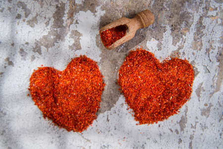 Presentation of two hearts made of chili powderの写真素材