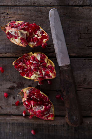 Presentation on wood dark pomegranate fruit peeled beans.の写真素材