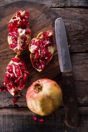 Presentation on wood dark pomegranate fruit peeled beans.の写真素材