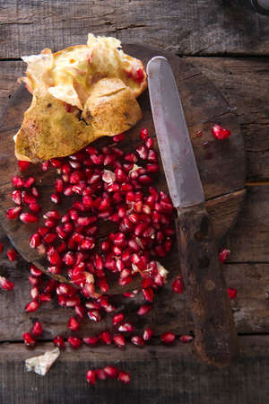 Presentation on wood dark pomegranate fruit peeled beans.の写真素材