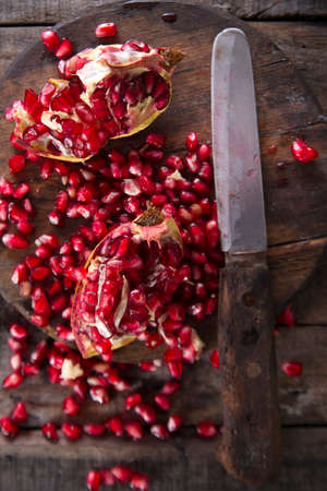 Presentation on wood dark pomegranate fruit peeled beans.の写真素材