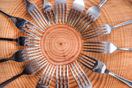 Series of different forks in a circle of pine boardの写真素材