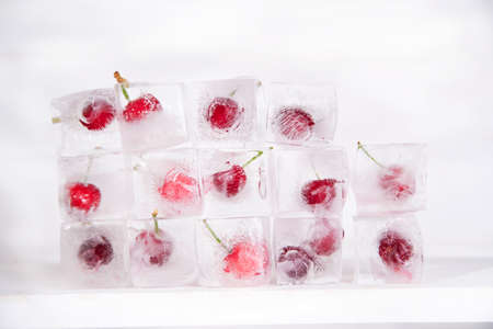 Presentations with ice cubes in cocktail cherries for summerの写真素材