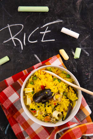 Spanish dish made of rice and fish with various vegetablesの写真素材