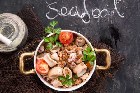 Presentation of a dish made with farro and seafoodの写真素材