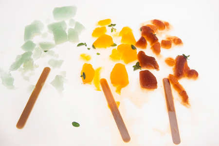 Fruit ice cream of different colors on white background crushedの写真素材