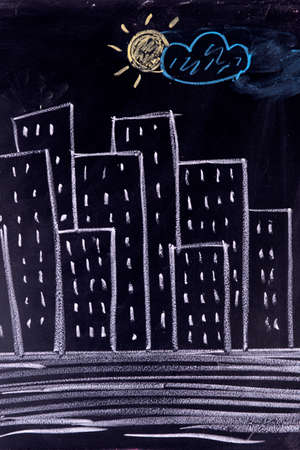 Graphical representation made with chalk on the blackboard of a silhouette of cityの写真素材