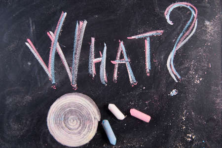 Graphic representation of the word with chalk on the blackboard whatの写真素材