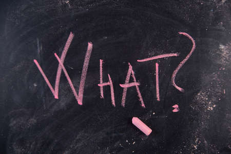 Graphic representation of the word with chalk on the blackboard whatの写真素材