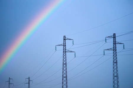 Effects arc of a rainbow near a high-voltage power lineの写真素材