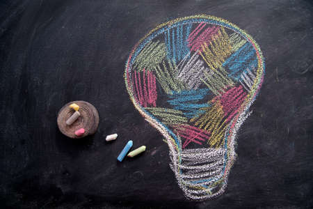 Graphic representation with chalk on the blackboard of the concept of multi-colored ideaの写真素材