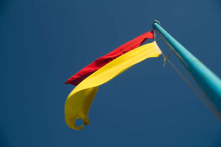 Yellow and red flags of danger without the supervised beachの写真素材