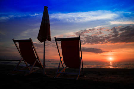 Chair on the beach seen at the sunset of the winter seaの写真素材