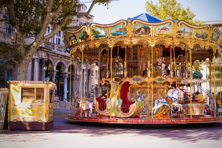 An old fashioned carousel sits in the middle of the square in Avignon, France のeditorial素材