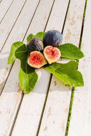 Fresh figs on wooden groundの写真素材
