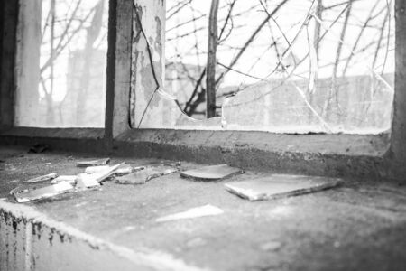 Broken glass at Window of old industrial urbex buildingの写真素材