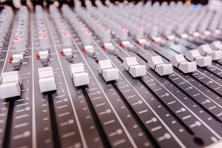 Closeup mixer in recording room. Closeup button to increase or decrease sound.