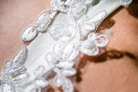 Details from the bride wedding dress and accessories in the sunの写真素材