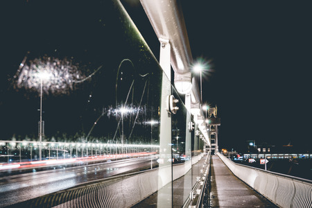 Modern architecture detail of bridge at night with lights, cars and views of the other side of the riverbank. Kampen, Overijssel - Netherlands.の写真素材