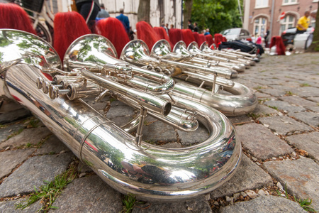 Details from a music, show and marching band. Composition of helmets and wind instruments, baritone on the street.の写真素材