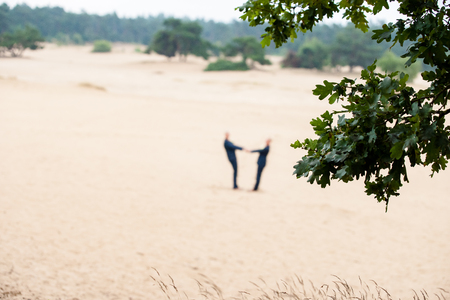 Two people on a sand surface on the Dutch Veluwe during a wedding report that can be used as a defocust backdrop imageの写真素材