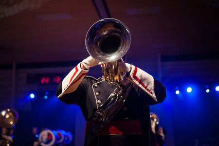 Details from a music, show and marching band. Playing musicians wind instruments in uniforms....