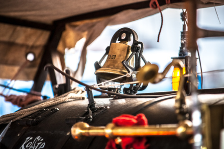 Vintage barista prepare coffee to customer in old style machine with handmade retro look and throwback clothes in an outdoor market stallの写真素材