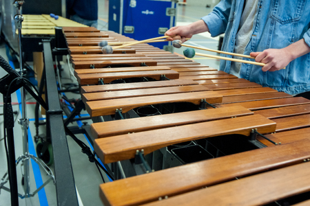 Musician in action with percussion instrument during a concert or performance