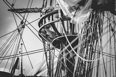 Detail of mast of ship. Detailed rigging with sails. Vintage sailing ship block and tackle. handmade...