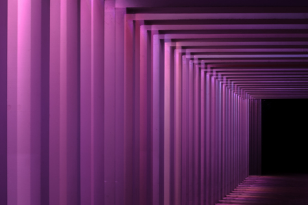 Details of a viaduct during a Night scene with an urban city look. Different colors illuminate...