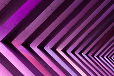 Details of a viaduct during a Night scene with an urban city look. Different colors illuminate...