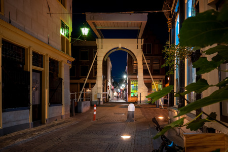 Details of streets, houses, alleys and canals in the old town of Alkmaar in North Holland. Beautifully illuminated city with monuments and locations, photographed in the evening and the night.の写真素材