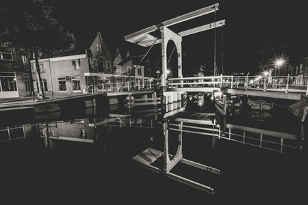 Details of streets, houses, alleys and canals in the old town of Alkmaar in North Holland. Beautifully illuminated city with monuments and locations, photographed in the evening and the night.の写真素材