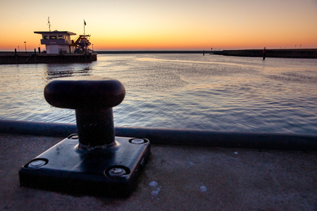 Empty unused mooring post in the Harlingen harbor in the North of the Netherlands.の写真素材