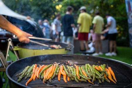 Tasty summer BBQ family together during garden partyの写真素材