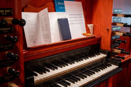 Details of a dutch church organ with housework, organ pipes and keyboardの写真素材
