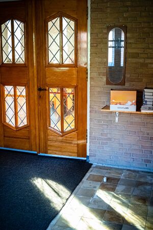 Colorful sunlight falls through the window of a church building with stained glass windowsの写真素材