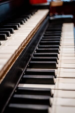 Details of a dutch church organ with housework, organ pipes and keyboardの写真素材