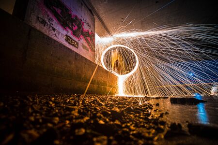 Burning Steel Wool spinning. Showers of glowing sparks from spinning steel wool