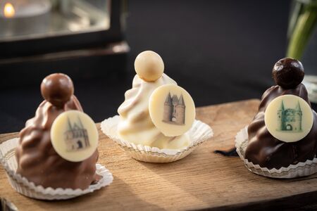 Mix of Chocolates on a table with black background, confectioners assortment of bon bon candiesの写真素材