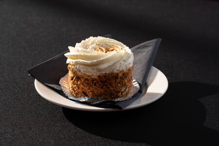 Mix of cakes on a table with black background, confectionery assortment for catering arrangements...