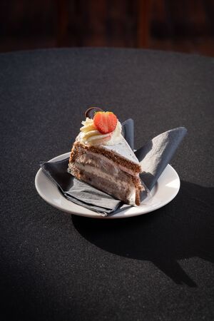 Mix of cakes on a table with black background, confectionery assortment for catering arrangements with coffeeの写真素材