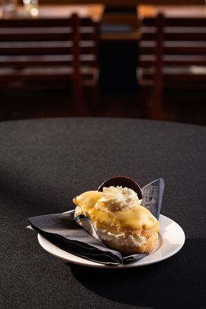 Mix of cakes on a table with black background, confectionery assortment for catering arrangements with coffeeの写真素材