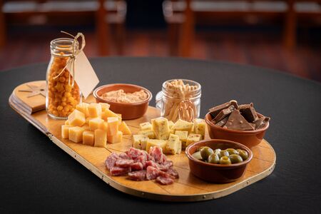 Overhead photo of a selection of cheeses, shot taken on a boat with rustic texture and maritime...