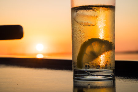 Freshly chilled cocktail with ice and water drops, with summer feeling on board a party shipの写真素材