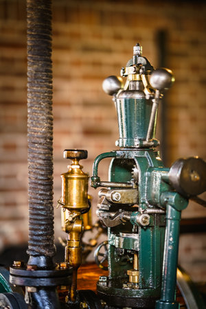 Vintage steam engine with boiler, old pipes and control valves for industrial useの写真素材