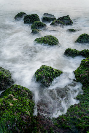 North Sea coast at nightly light and long exposure, under sinking sun irradiates bricks and stones...